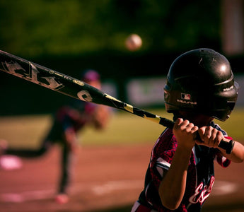 kid at bat practicing good hitting rhythm