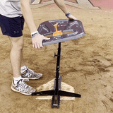baseball player testing the sturdiness of the swing path trainer